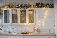 Christmas decor on top of kitchen cabinets